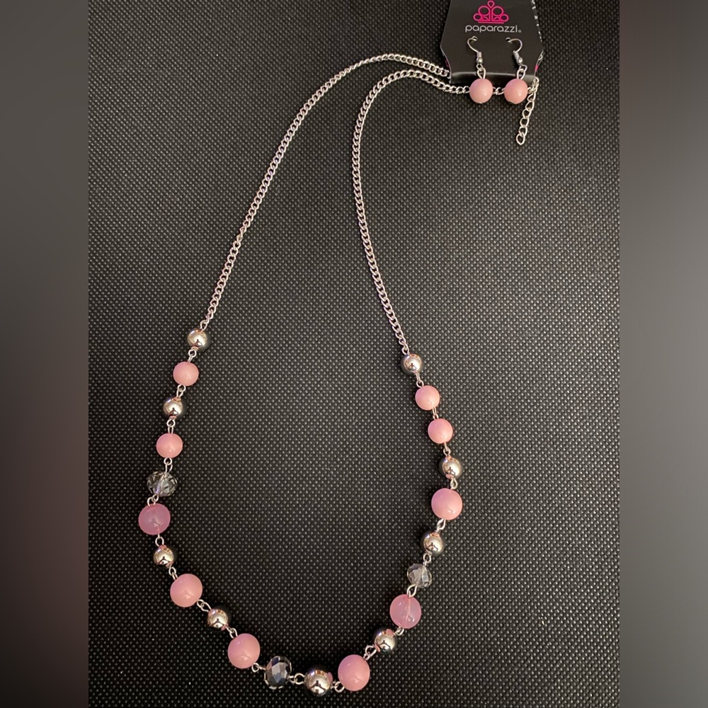 *Long silver and pink necklace.